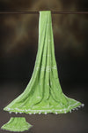 Light green cotton saree with delicate white motifs and tassel detailing.
